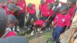 Plumbers working on a leaking pipe in the community
